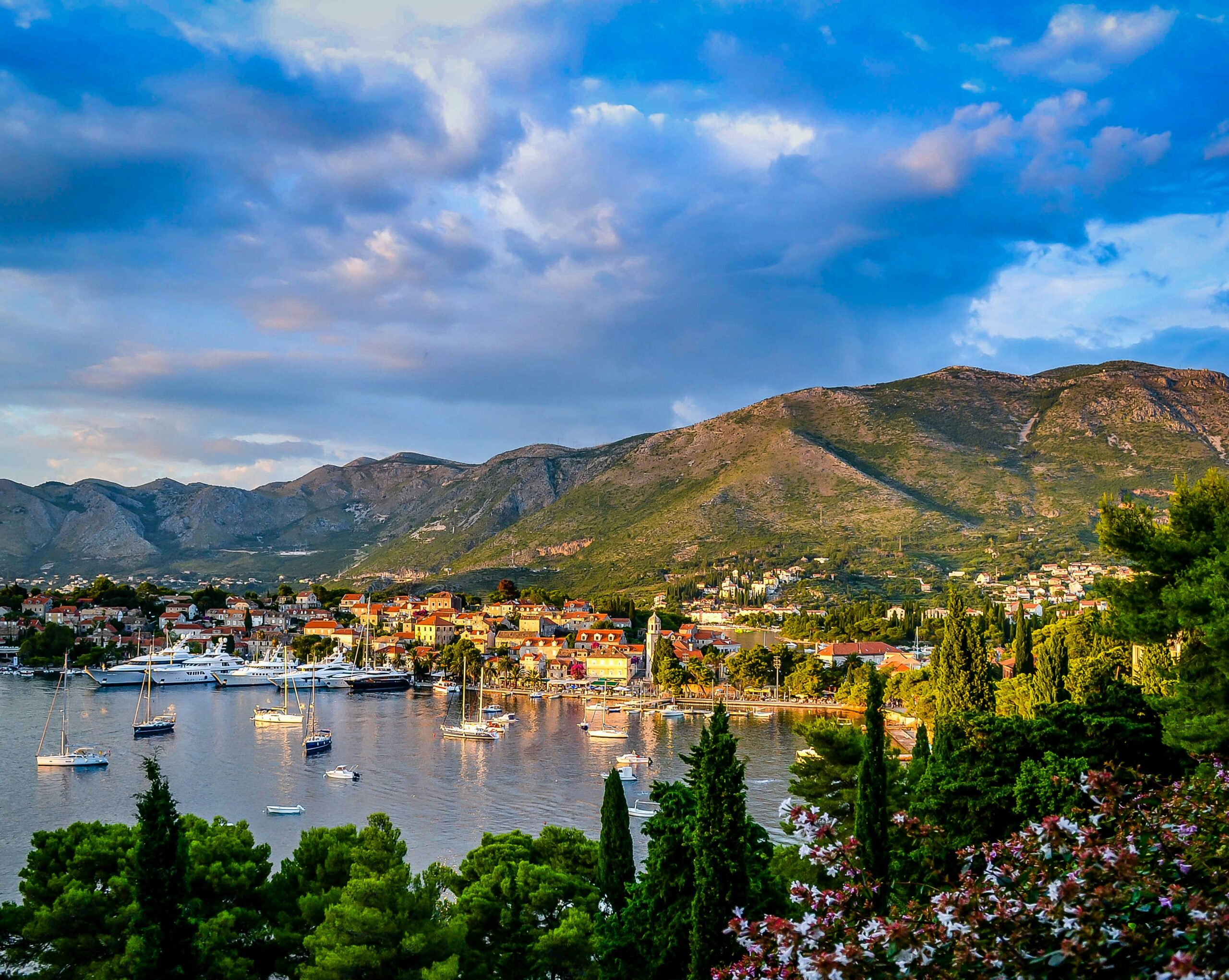 Scenic coastal town with mountains backdrop