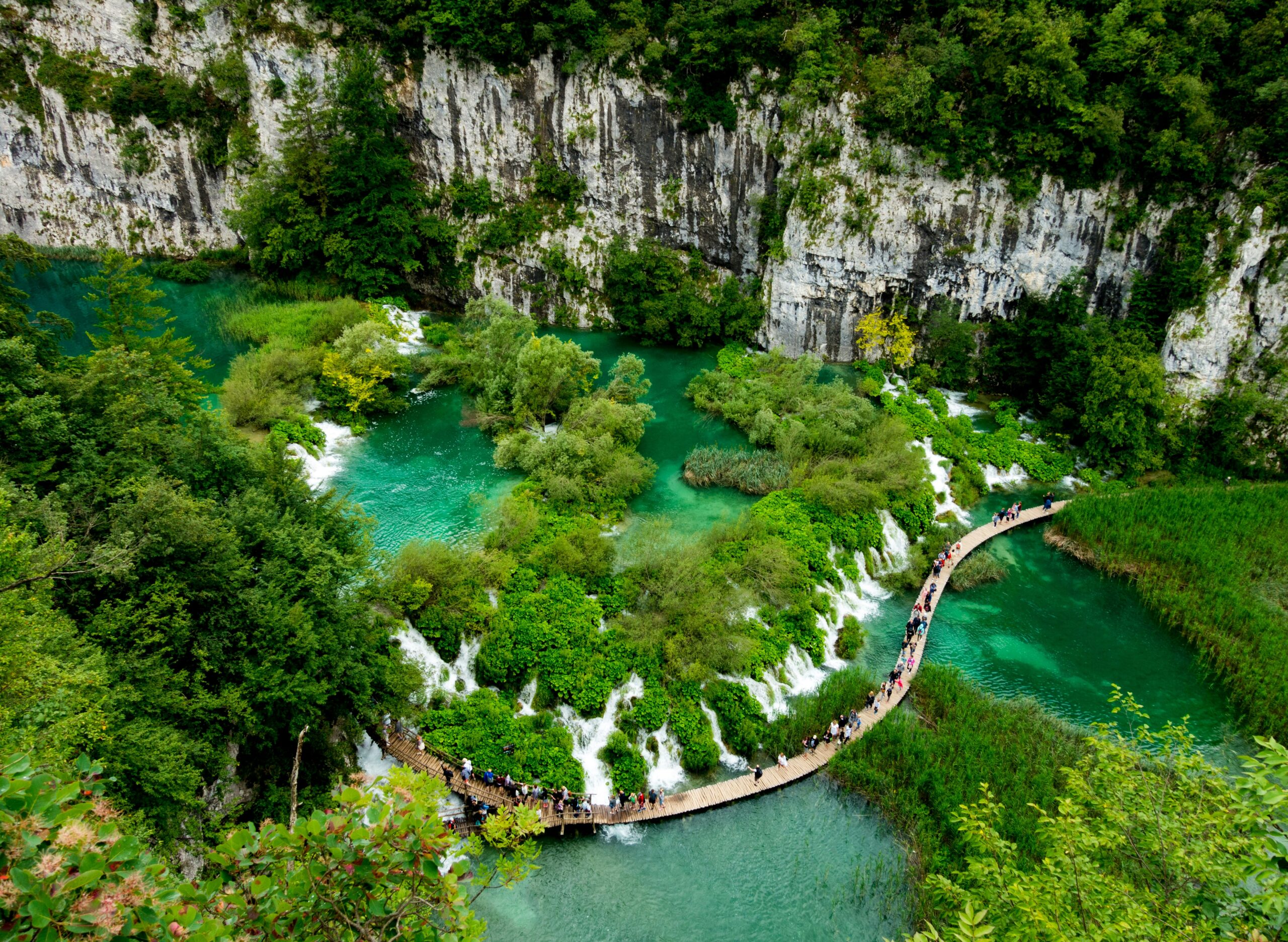 Plitvice Lakes wooden boardwalk over emerald cascades