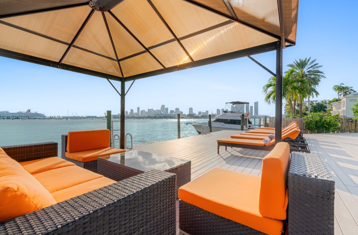 Short Flights from NYC to the Beach: Sun & Sand Fast 2 Venetian Star terrace and private dock on Biscayne Bay, with the Miami skyline beyond
