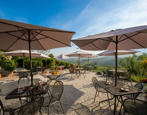 Tables and umbrellas on the panoramic terrace of Davinia, in the Chianti hills