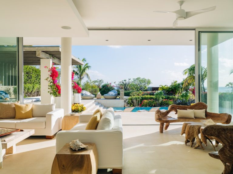 Luxury Villa Rentals and Mansions for Rent | Haute Retreats | 16 Sitting room of a private resort villa in Anguilla, open to the pool and gardens