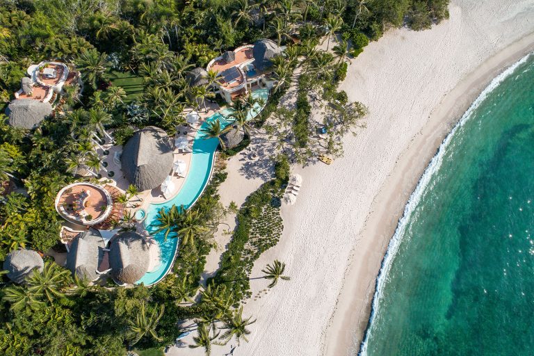 Luxury Villa Destinations Worldwide | Haute Retreats 8 Casa Palmasola from the air: palapa roofs, a long pool among the palms and the white-sand beach