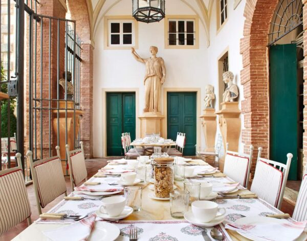 A long table laid for a meal in the hall of Villa Cetinale, near Siena
