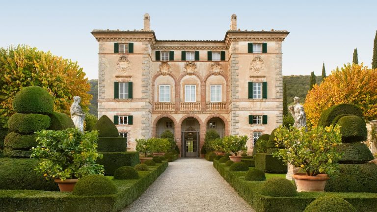 Luxury Villa Destinations Worldwide | Haute Retreats 9 The Baroque facade of Villa Cetinale near Siena, seen down a gravel walk between clipped box hedges