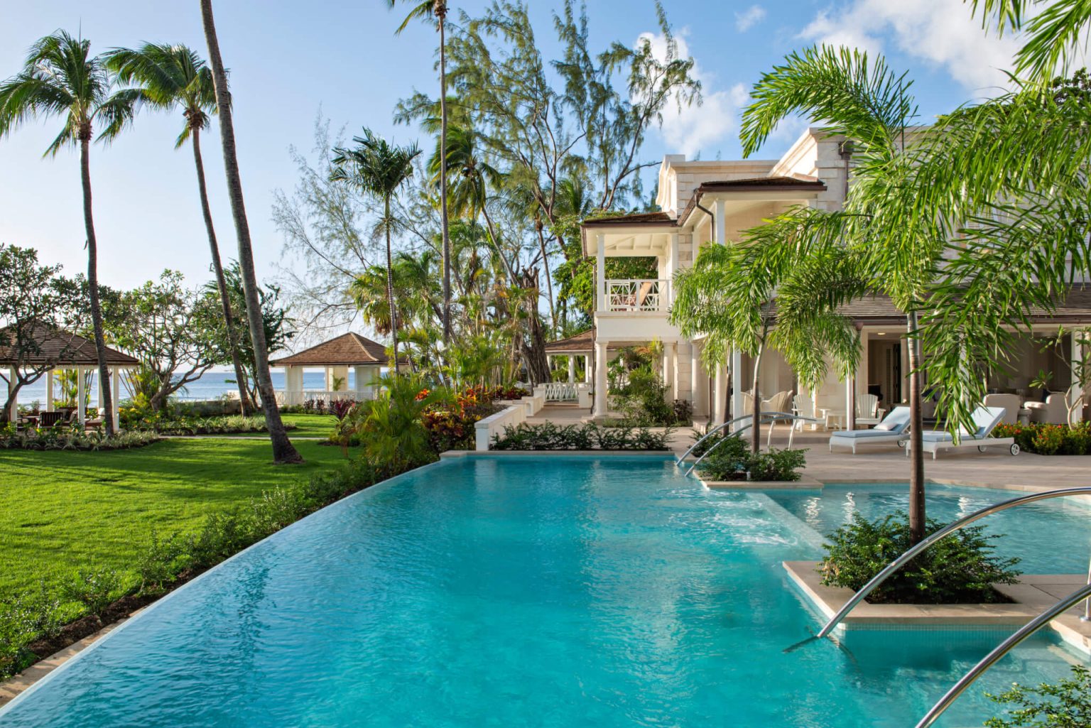 Barbados Villas | Luxury Villa Rentals in Barbados 1 Infinity pool among palms in front of The Great House, a beachfront estate in St Peter, Barbados