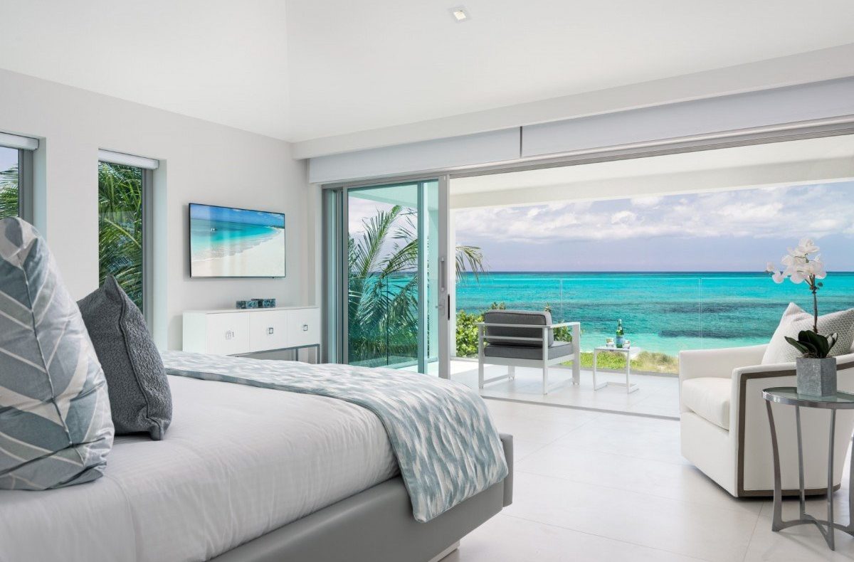 a bedroom with a view of the ocean in turks and caicos