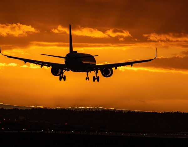 A plane landing at sunset