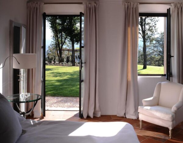 A bedroom opening onto the garden at a villa in Umbria