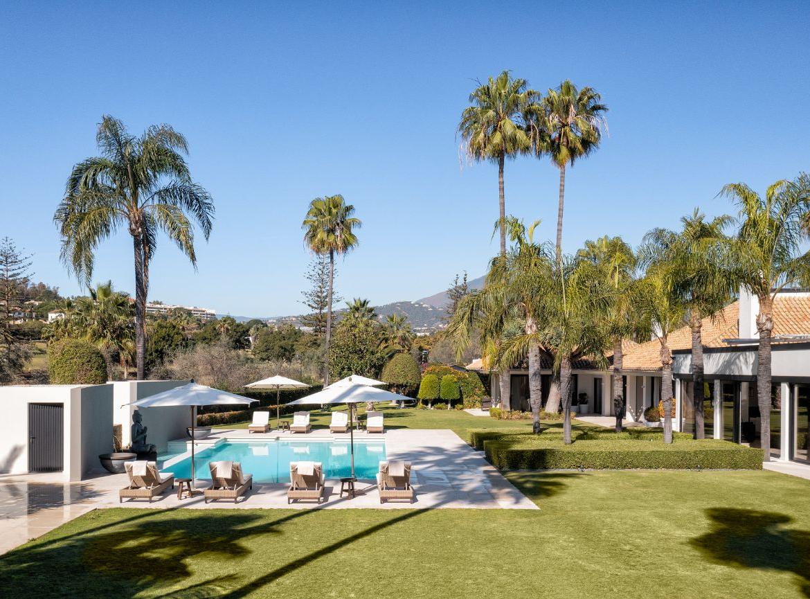 Discover Villa Los Jazmines in Nueva Andalucía, Spain—13 luxurious bedrooms, modern design, pools, a gym, and more in a secure community.