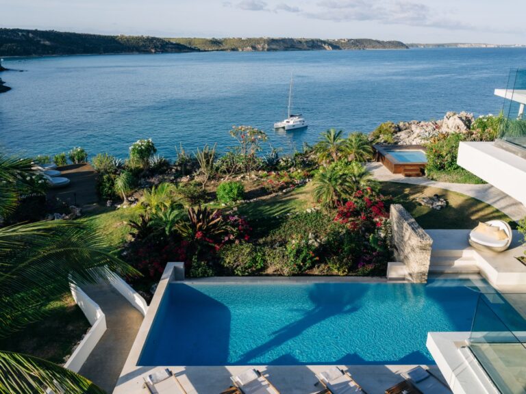 A villa pool above the gardens and the bay at the West End of Anguilla