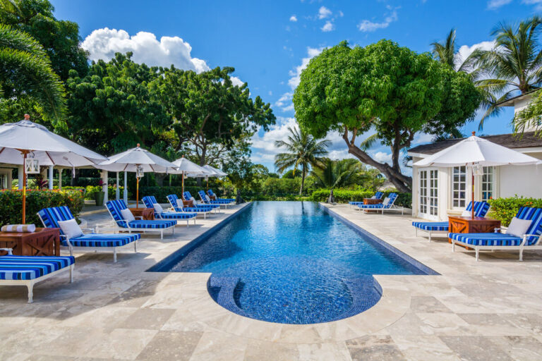 Where Is Barbados? 100 Miles East of the Caribbean Chain 7 Long pool lined with striped loungers and white umbrellas at Casablanca, a villa on the Sandy Lane Estate