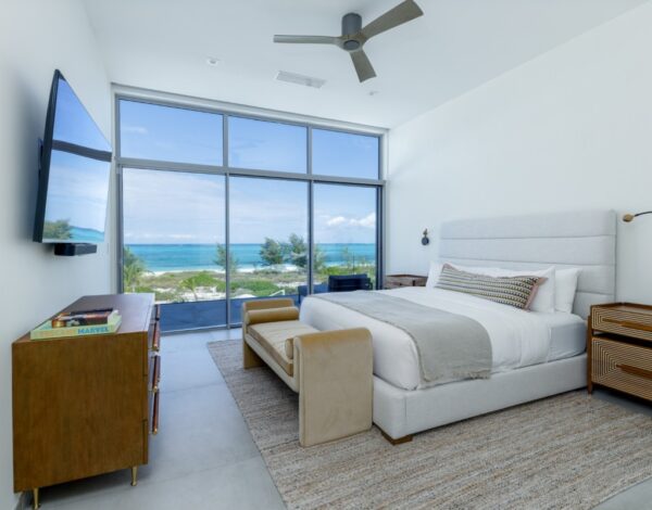 Bedroom at Bliss Four with floor-to-ceiling glass facing the sea, Grace Bay
