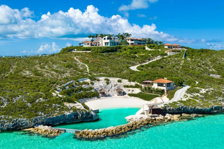 Villa Bajacu from the air, on its headland above a turquoise cove and its own beach at Turtle Tail