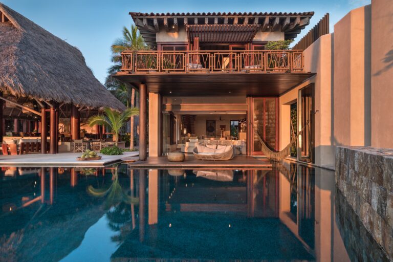 The house and pool of Koko Retreat, its terraces reflected in the water