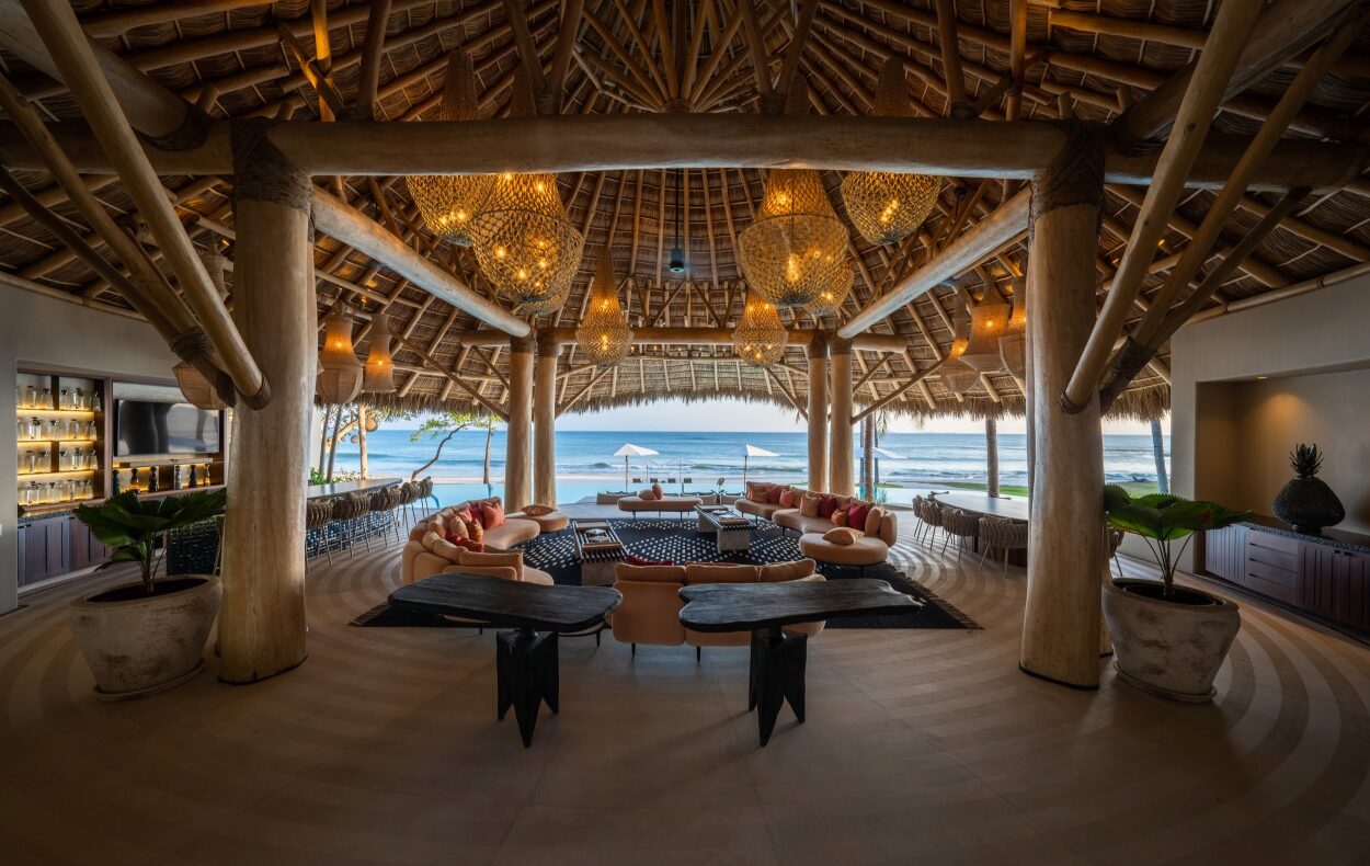Luxurious beachfront lounge with tropical decor.