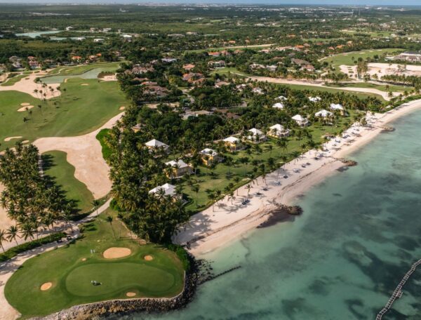 Lush coastline with golf course view.