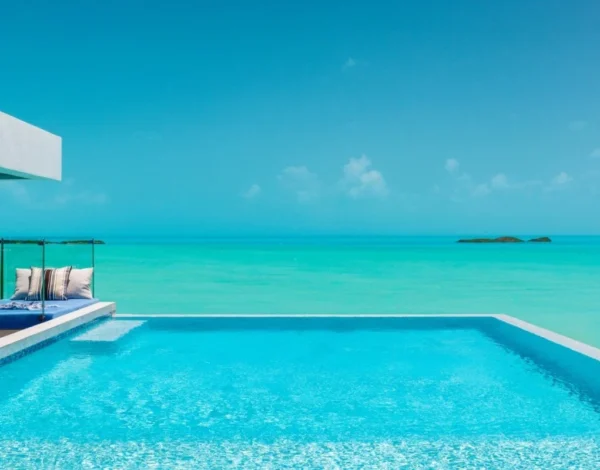 An infinity pool above the turquoise water of Turks and Caicos