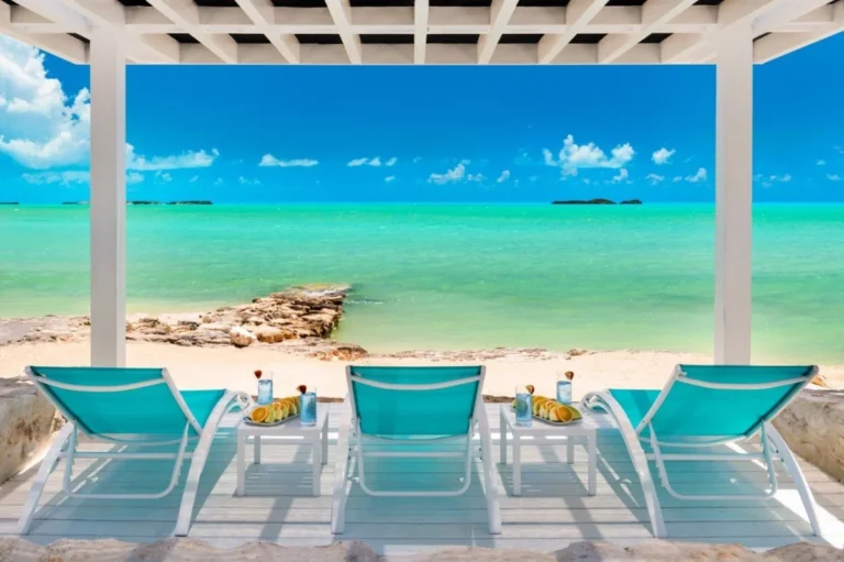 Beachfront view with lounge chairs. Turks and Caicos travel guide 