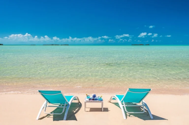 Beach chairs by clear turquoise water
