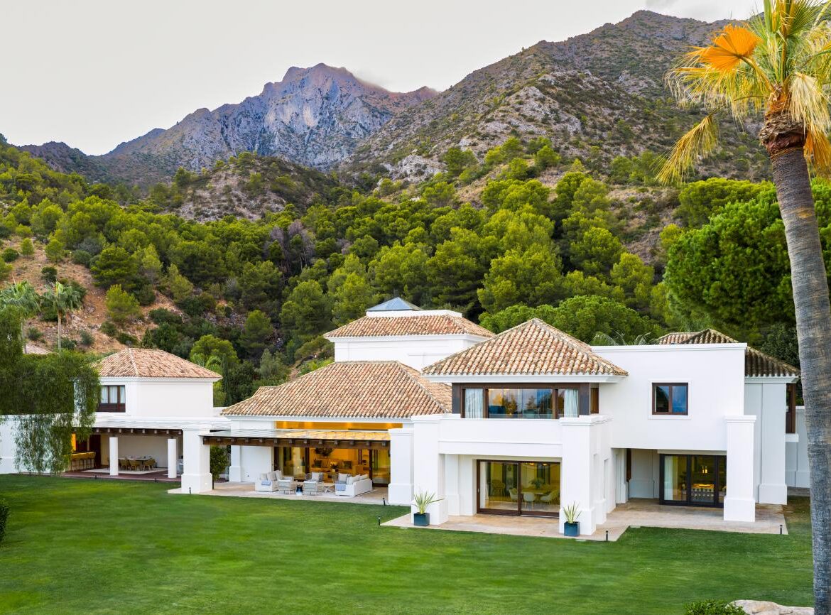 Villa El Mirador, a white villa with terracotta roofs and a lawn below the peaks of Sierra Blanca, Marbella