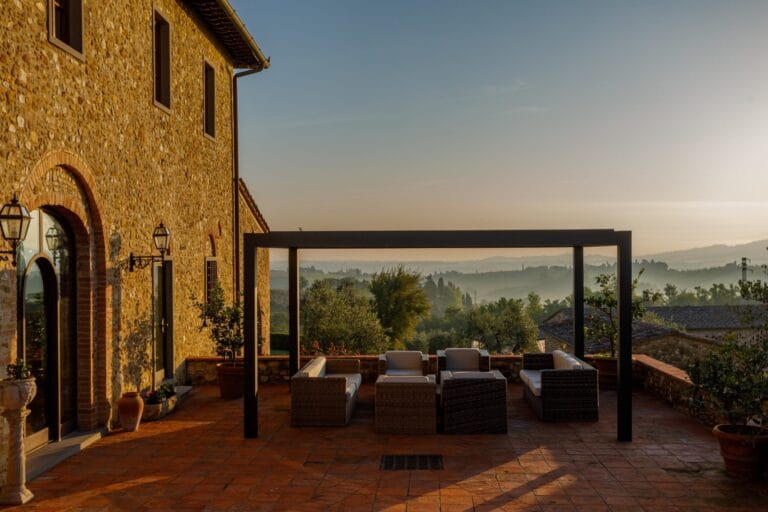 Stone terrace of Villa Pesa at dusk above the Chianti hills
