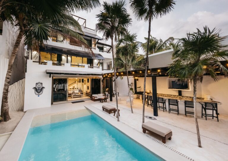 The pool and white house of Villa Soliman among the palms, Soliman Bay