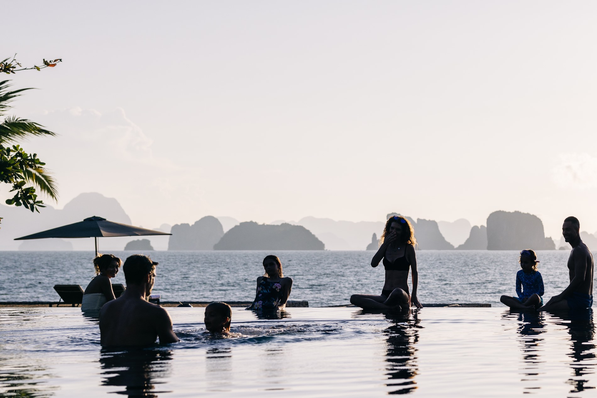Infinity pool of a luxury Haute Retreats villa overlooking the ocean at sunset