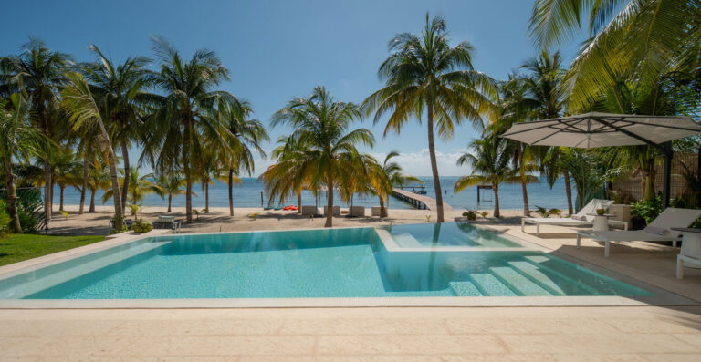 The pool of Casa Azul among the palms, facing the sea off Isla Mujeres