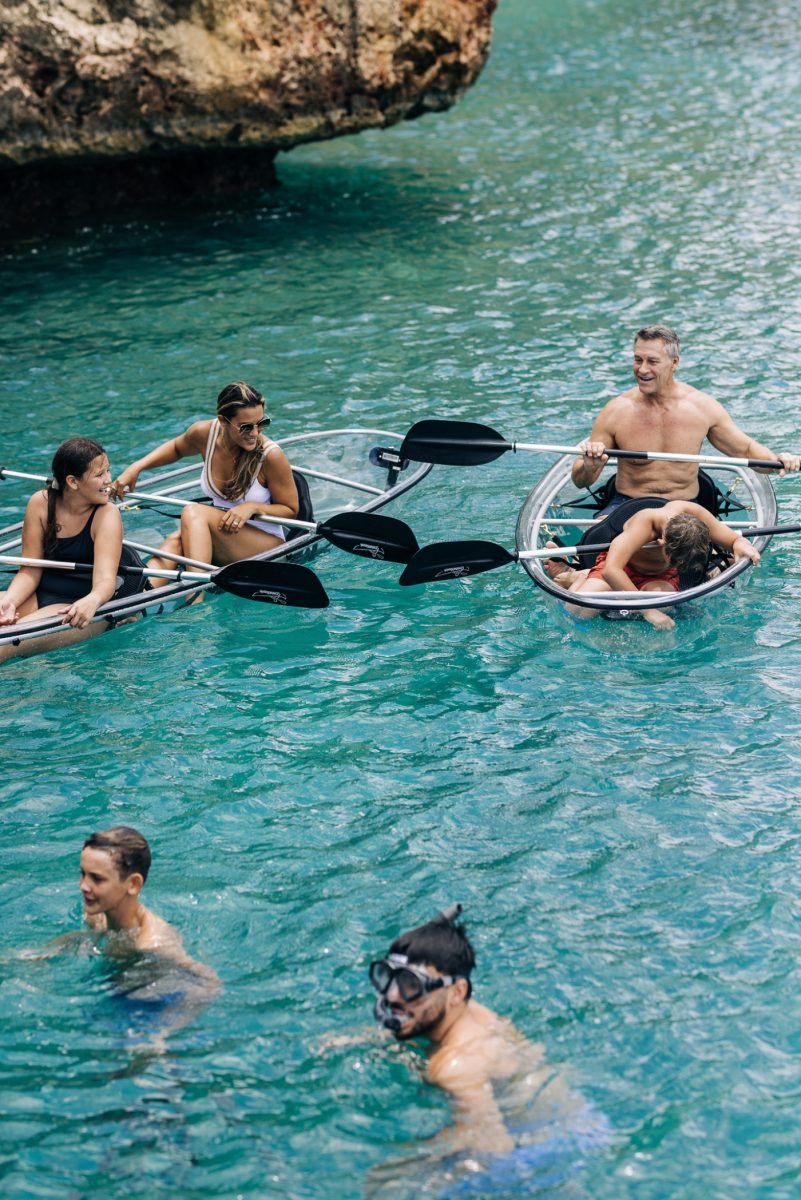 People kayaking and swimming in water. Anguilla villas